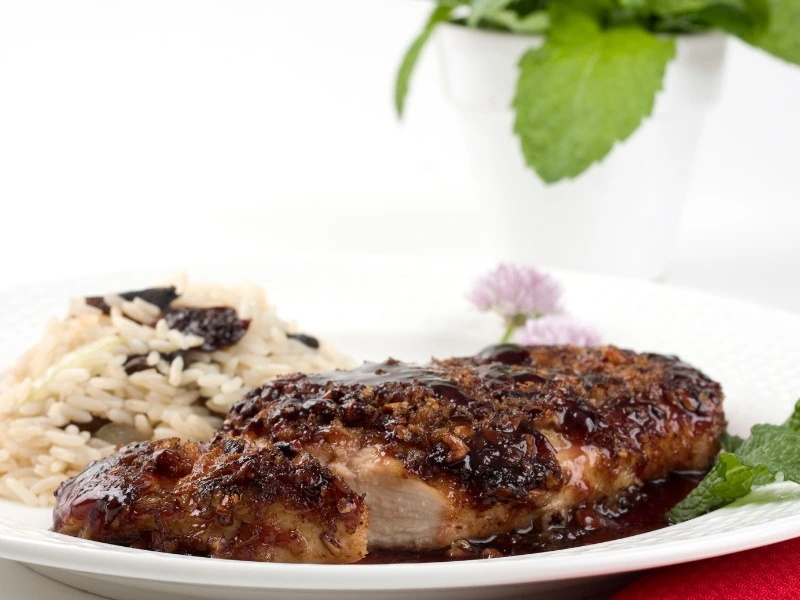 Pecan-crusted grouper on a plate served with rice. 