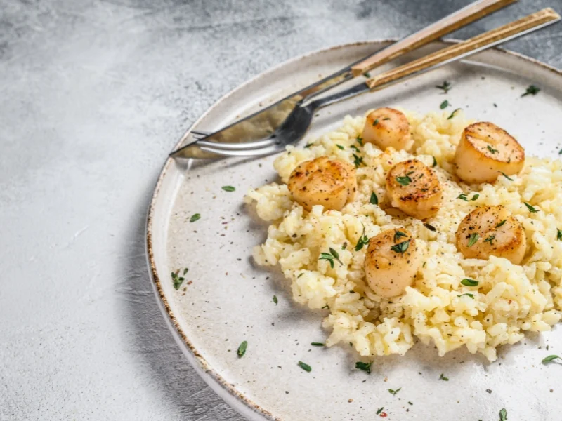 Risotto with pan-seared scallops, pictured here,  is one of our favorite Thanksgiving seafood dishes